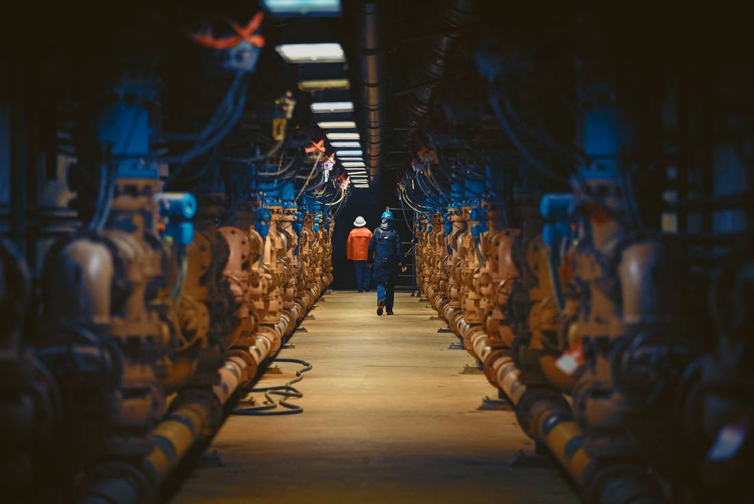 A crew member walking through a pump gallery